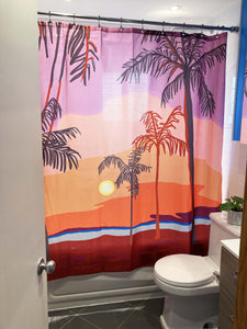 Shower curtain made by Canadian artist Anne Faf. Sunset tropcial beach artwork in purple red and orange shades with palm trees
